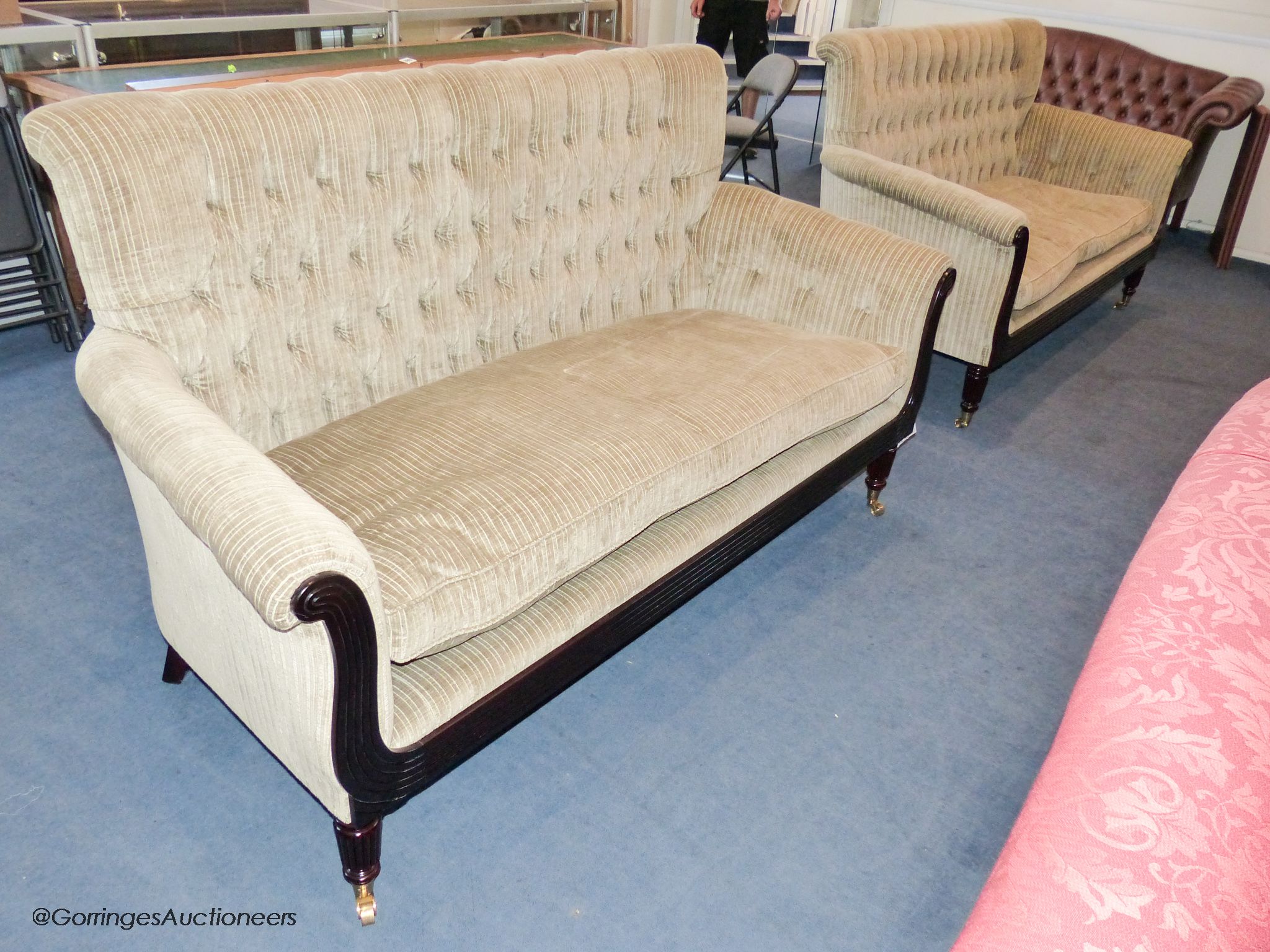 A pair of George IV style mahogany button back sofas, 181 cm wide